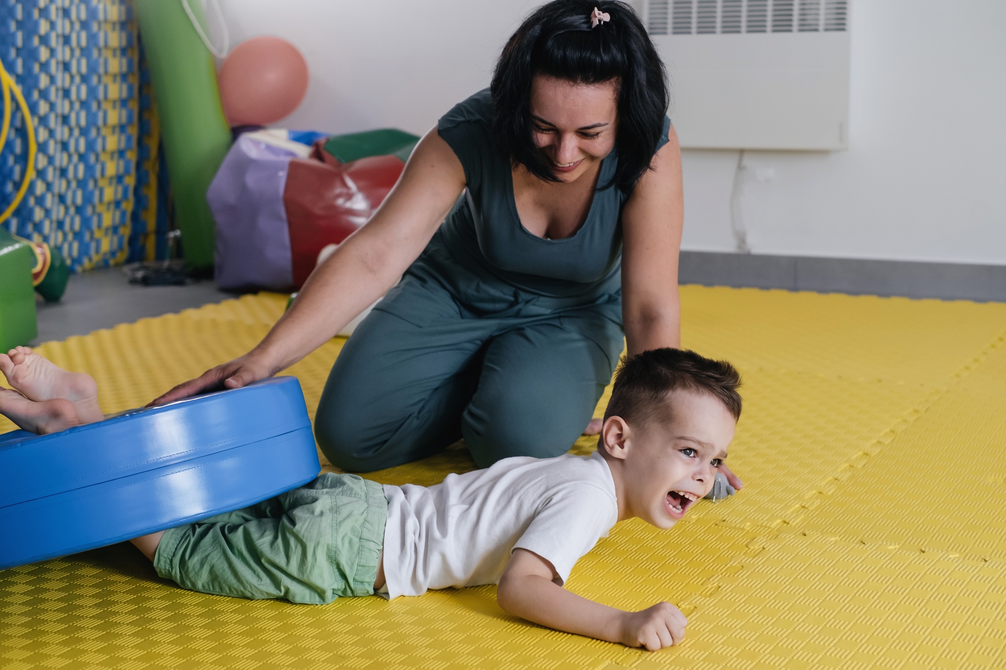 therapist doing rehabilitation of children with cerebral palsy